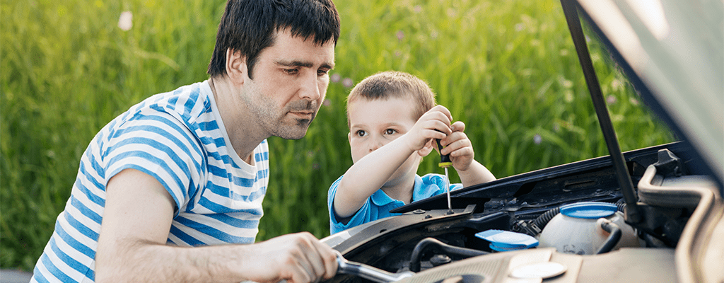 dad educating child on car repairs during quarantine