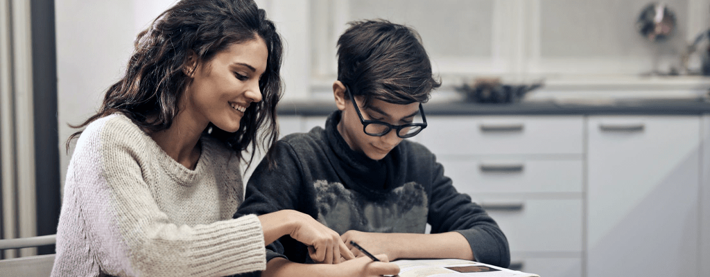 mother and teenager studying at home and practicing social distancing
