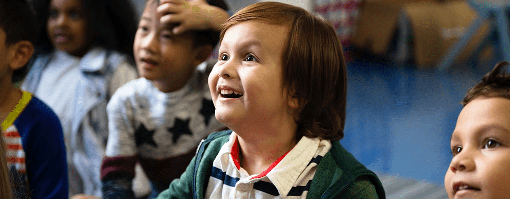 child excited in class that uses multiple intelligence while teaching concepts